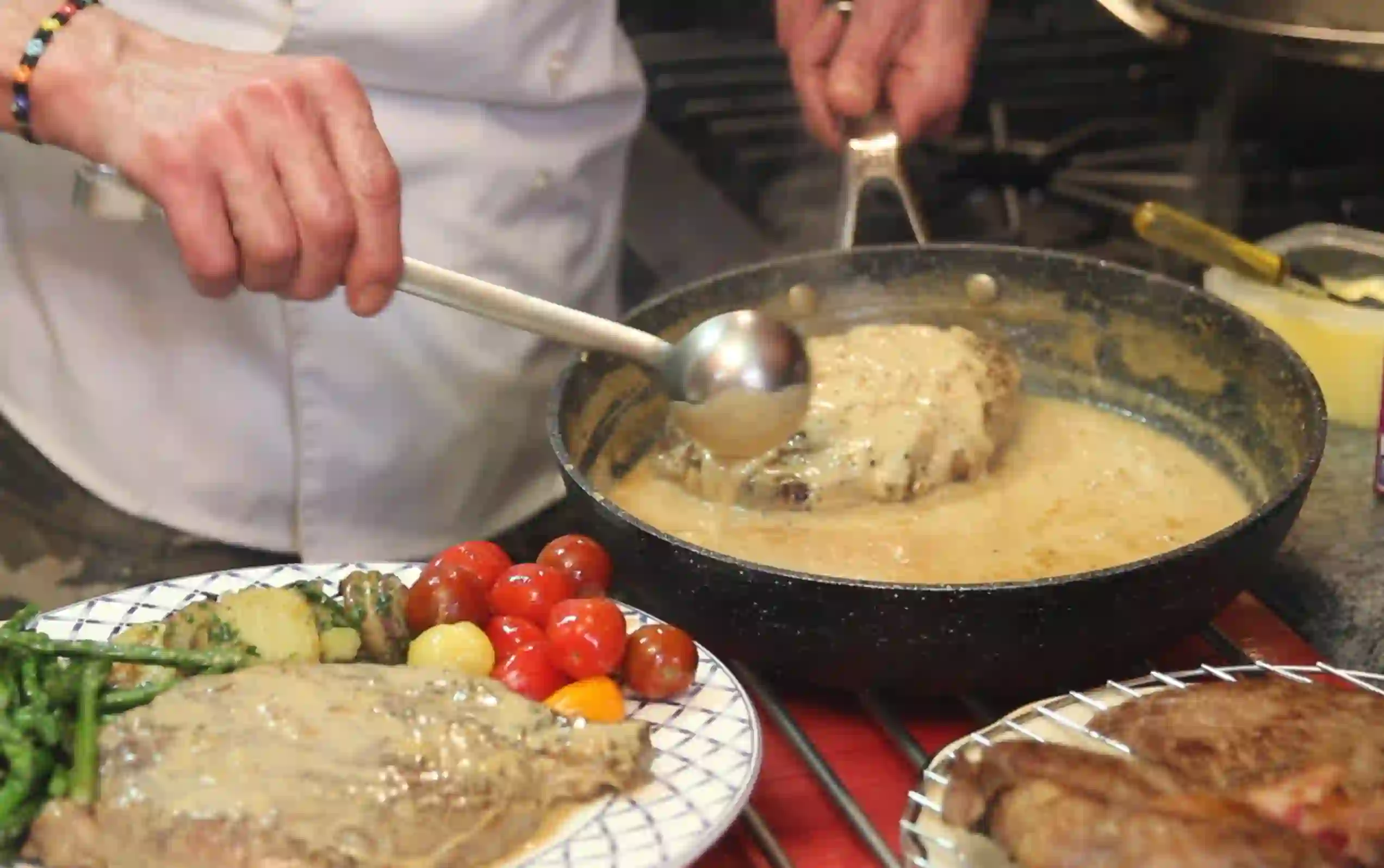 Roquefort sauce spooned over steak in the kitchen
