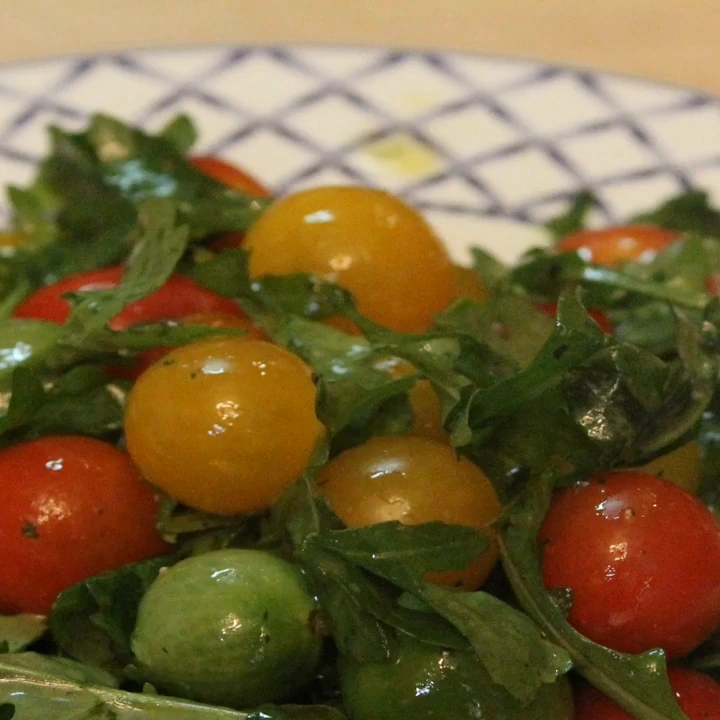 arugula cherry tomato salad mint lemon dressing, finished dish
